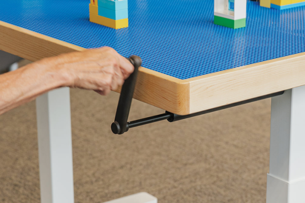 Simple handle turn for adjustable height activity table